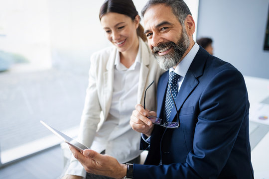 Successful Team Leader And Business Owner Leading Informal In-house Business Meeting