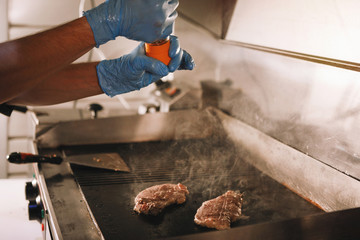Cook prepares a hamburger.
