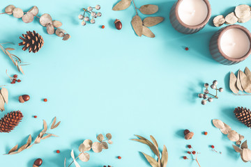 Winter composition. Dried leaves, berries, pine cones on pastel blue background. Autumn, fall, winter concept. Flat lay, top view, copy space