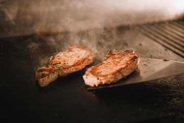 Cook prepares a hamburger.