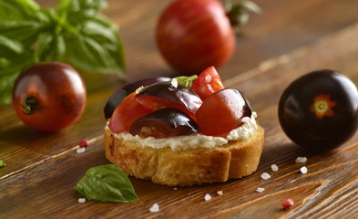 Bruschetta with soft cheese, tomatoes and basil