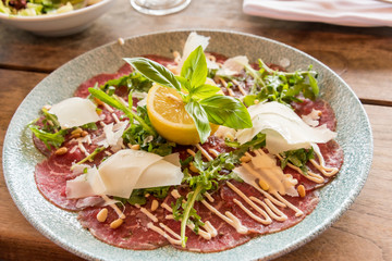 White dish with carpaccio of beef