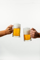 Hands toasting with beer on white background