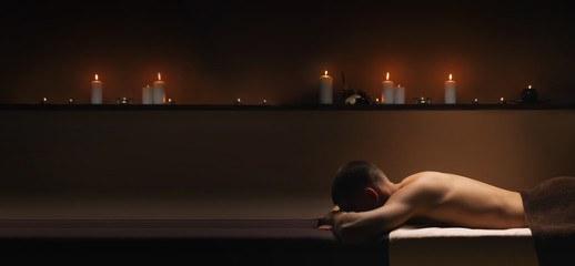 Man relaxes at SPA. Calm, pacifying atmosphere around.