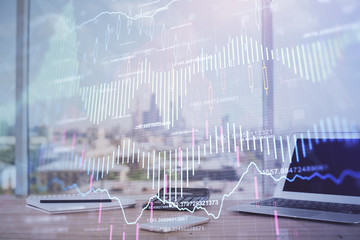 Forex Chart hologram on table with computer background. Multi exposure. Concept of financial markets.