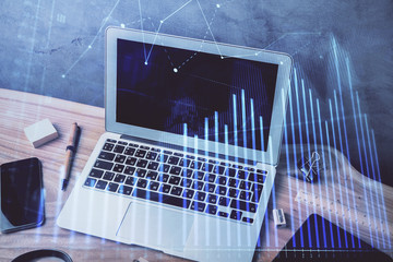 Multi exposure of graph and financial info and work space with computer background. Concept of...