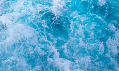 Sea surface texture. Blue water wave photo. Blue sea water mesh. Motor boat trail on blue ocean surface. Cruise liner or ship tail