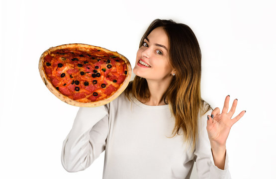 Woman eating pizza. Smiling woman hold pizza. Woman shows sign okay. Ok. Food. Lunch. Happy girl holding pizza slices in hands. Fastfood. Snack. Food delivery. Copy space. Pizza slice. Sign okay.