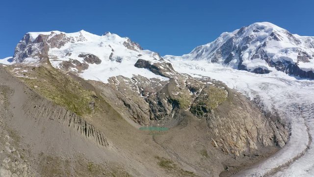 Aerial shot flying laterally and looking towards the Monte Rosa massif. Zermatt, Switzerland
