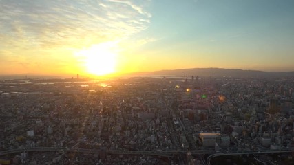 OSAKA, JAPAN - CIRCA SEPTEMBER 2019 : Aerial high angle view of CITYSCAPE of OSAKA. Time lapse shot, sunset to night. Osaka is the second largest metropolitan area in Japan.