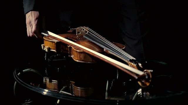 Dolly shot of girl playing violin, closeup hands and bottom of head