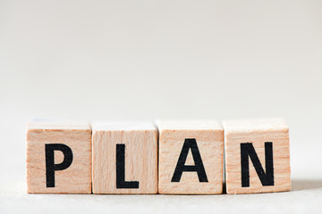 word PLAN on wooden cube block