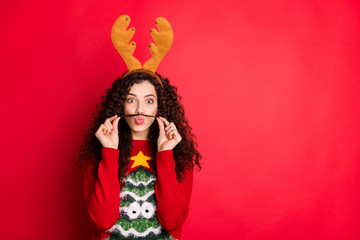 Photo of funny lady making moustache with one curl acting liked guy want win costume competition wear head horns pullover with green tree isolated red color background