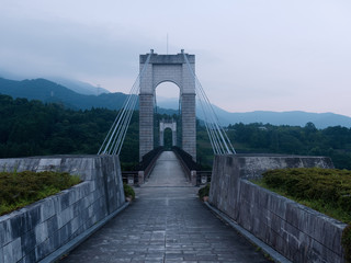 Suspension bridge in the forest at dusk. Photographed at Hadano Togawa Park, Kanagawa Prefecture, Japan.