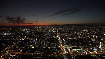 OSAKA, JAPAN - CIRCA SEPTEMBER 2019 : Aerial high angle sunrise view of CITYSCAPE of OSAKA. Time lapse shot, night to morning. Osaka is the second largest metropolitan area in Japan.