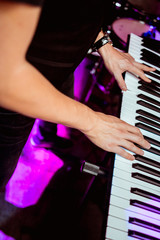playing the synthesizer concert, hands on the keys