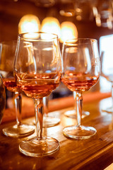 Cold and refreshing summer cocktail. Drinks and hospitality concept. Vertical image with selective focus. Glass of cocktail in the front, other bottles are behind in the background.
