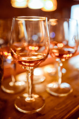 Cold and refreshing summer cocktail. Drinks and hospitality concept. Vertical image with selective focus. Glass of cocktail in the front, other bottles are behind in the background.