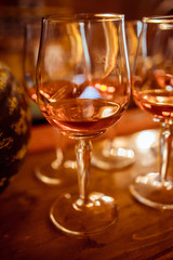 Cold and refreshing summer cocktail. Drinks and hospitality concept. Vertical image with selective focus. Glass of cocktail in the front, other bottles are behind in the background.