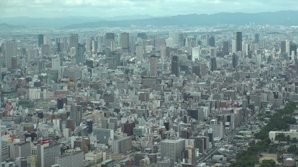 OSAKA, JAPAN - CIRCA SEPTEMBER 2019 : Aerial high angle view of CITYSCAPE of OSAKA in daytime. Osaka is the second largest metropolitan area in Japan. Time lapse shot.