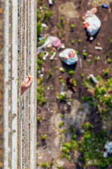 28/07/2019 Zhytomyr, Ukraine, a man smokes a cigarette on the balconies against the background of debris on the roofs of the lower floor