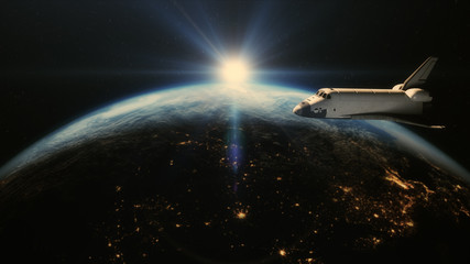 Space shuttle in orbit above earth
