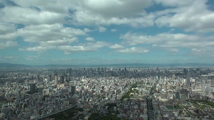 OSAKA, JAPAN - CIRCA SEPTEMBER 2019 : Aerial high angle view of CITYSCAPE of OSAKA in daytime. Osaka is the second largest metropolitan area in Japan. Time lapse shot.