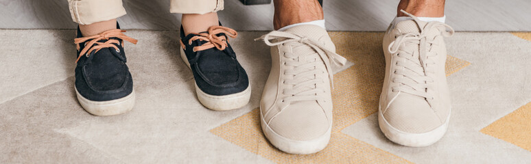 panoramic shot of legs of father and son