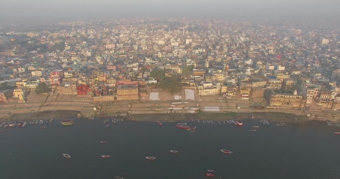 Drone Shot flying away from the coastline in India revealing the entire city of Varanasi. 