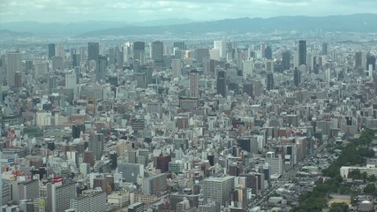 OSAKA, JAPAN - CIRCA SEPTEMBER 2019 : Aerial high angle view of CITYSCAPE of OSAKA in daytime. Osaka is the second largest metropolitan area in Japan. Time lapse shot.