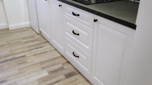 Man demonstrating soft closing kitchen drawers