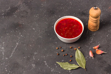 Vegetarian borsch in a bowl. Plate of beetroot soup on a black background. Traditional Ukraine Russian food cuisine. The concept of vegetarian and organic foods. Top view, copy space.