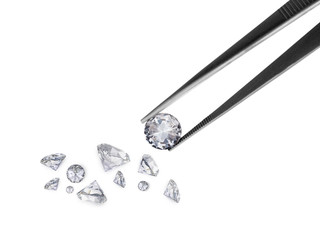 brilliant cut diamond held by tweezers