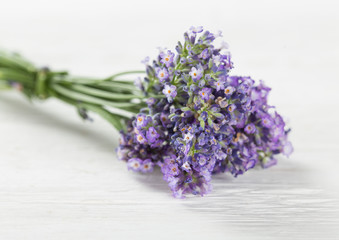 Wellness treatments with lavender flowers on wooden table. Spa still-life.