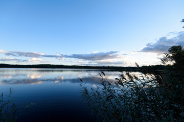 Sunset on the lake. Beautiful sunset nature. Evening landscape. Clouds over the lake.