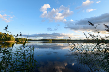 Sunset on the lake. Beautiful sunset nature. Evening landscape. Clouds over the lake.