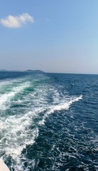 waves breaking on the sea behind the boat with birds