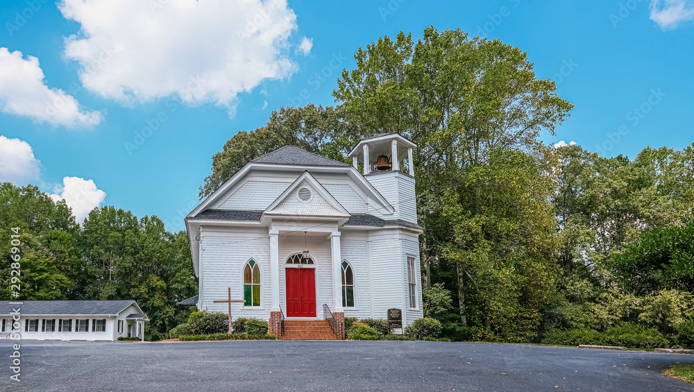 Sticker Small White Church with Red Door by Trees on a Hill