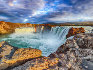 Breathtaking sunset landscape scene of powerful Godafoss waterfall