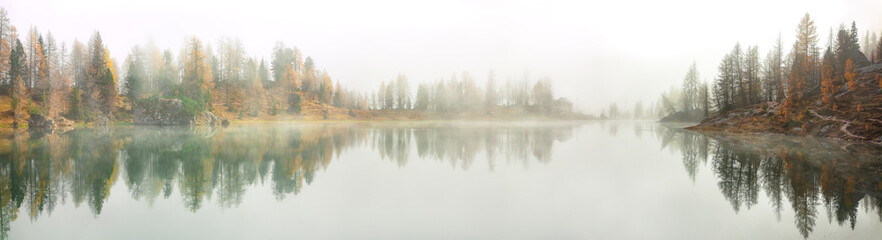 Dramatic foggy autumn landscape. View on Federa Lake early in the morning at autumn