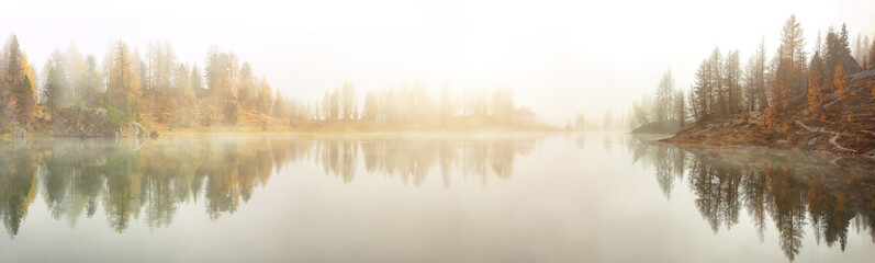 Dramatic foggy autumn landscape. View on Federa Lake early in the morning at autumn