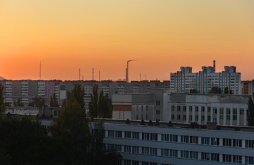 View of the facades of the houses from the roof of a high-rise building. Gomel city in the sunset light.