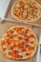 Italian pepperoni pizza in the cardboard box close up