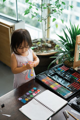 Portrait of adorable little asian girl being creative and working on a painting for artwork. Confidence Positivity Freedom Be Creative Concept.