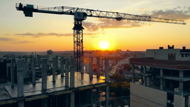 Urban buildings are getting constructed at sunset
