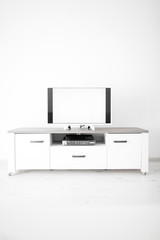 TV with white screen on a stand in the room.