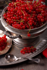 Fresh berries of red currant on a vintage tableware