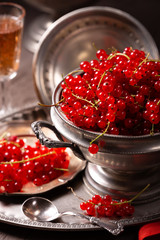 Fresh berries of red currant on a vintage tableware