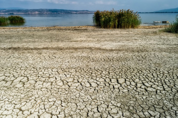 Dry lake bed with natural texture of cracked clay in perspective floor