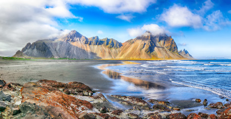 Fantastic sunny day and dramatic black sand beach on Stokksnes cape in Iceland.